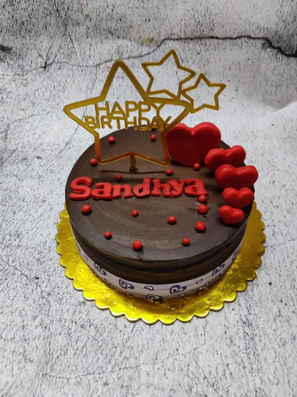 Chocolate birthday cake with gold topper
