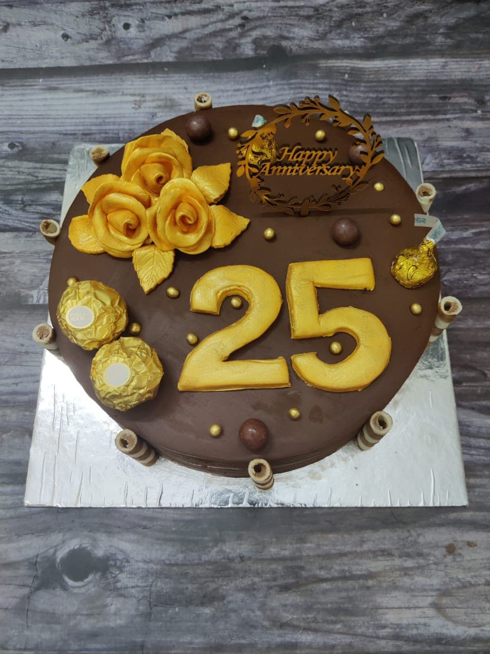 25th anniversary chocolate cake with gold roses